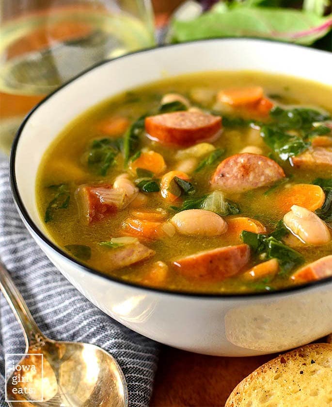 A hearty sausage and bean soup with nutritious spinach and kale