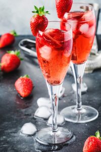 Sparkling Wine with Strawberries in Champagne Glasses