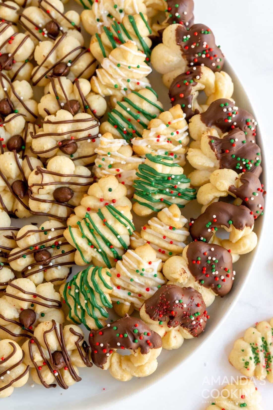 Different shaped spritz cookies drizzled and covered with chocolate. 