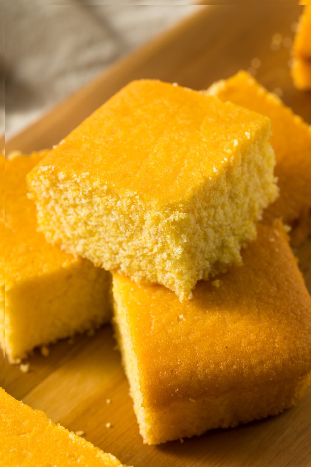 Stacks of Cornbread on a wooden cutting board
