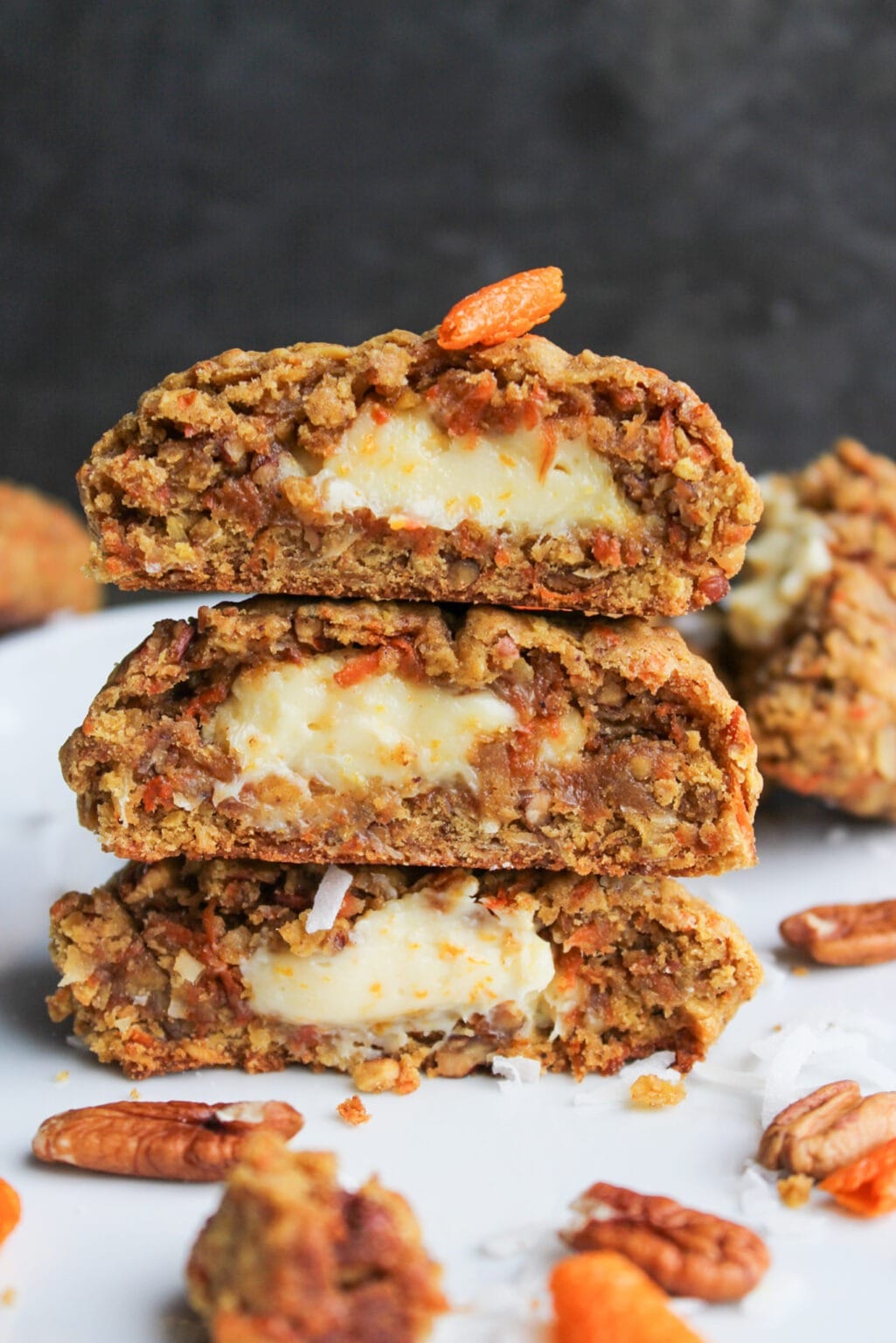 Stacks of homemade Stuffed Carrot Cake Cookies with pecans
