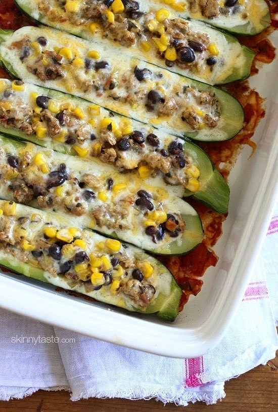 Zucchini boats stuffed with ground turkey, corn and beans baked on a casserole dish.