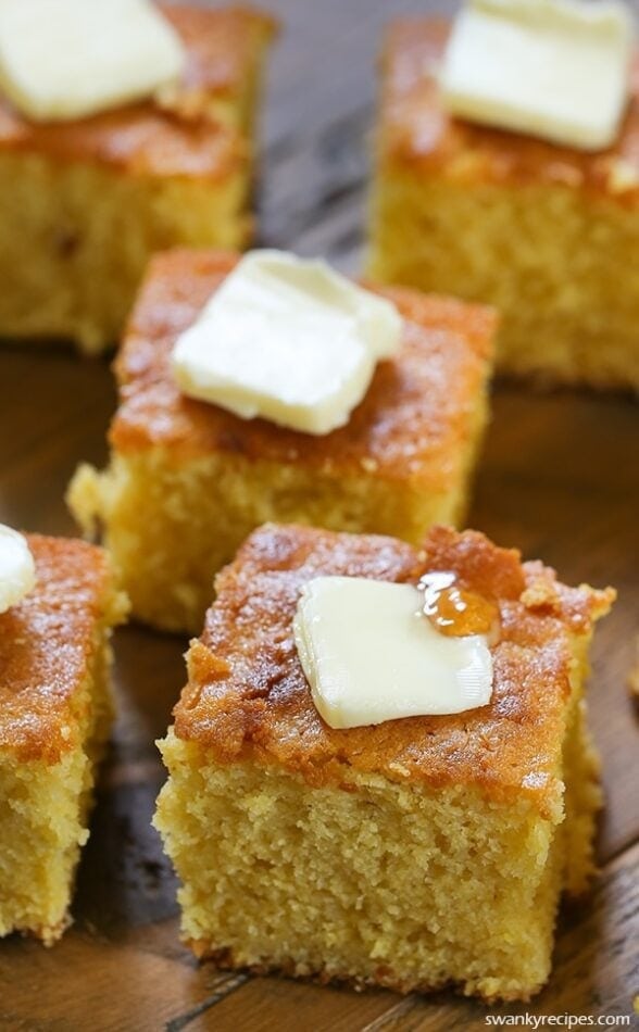 Square slices of Sweet Buttermilk Cornbread with butter on top