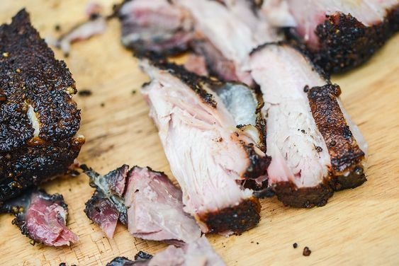 Texas-Style Smoked Pork Belly on a wooden cutting board