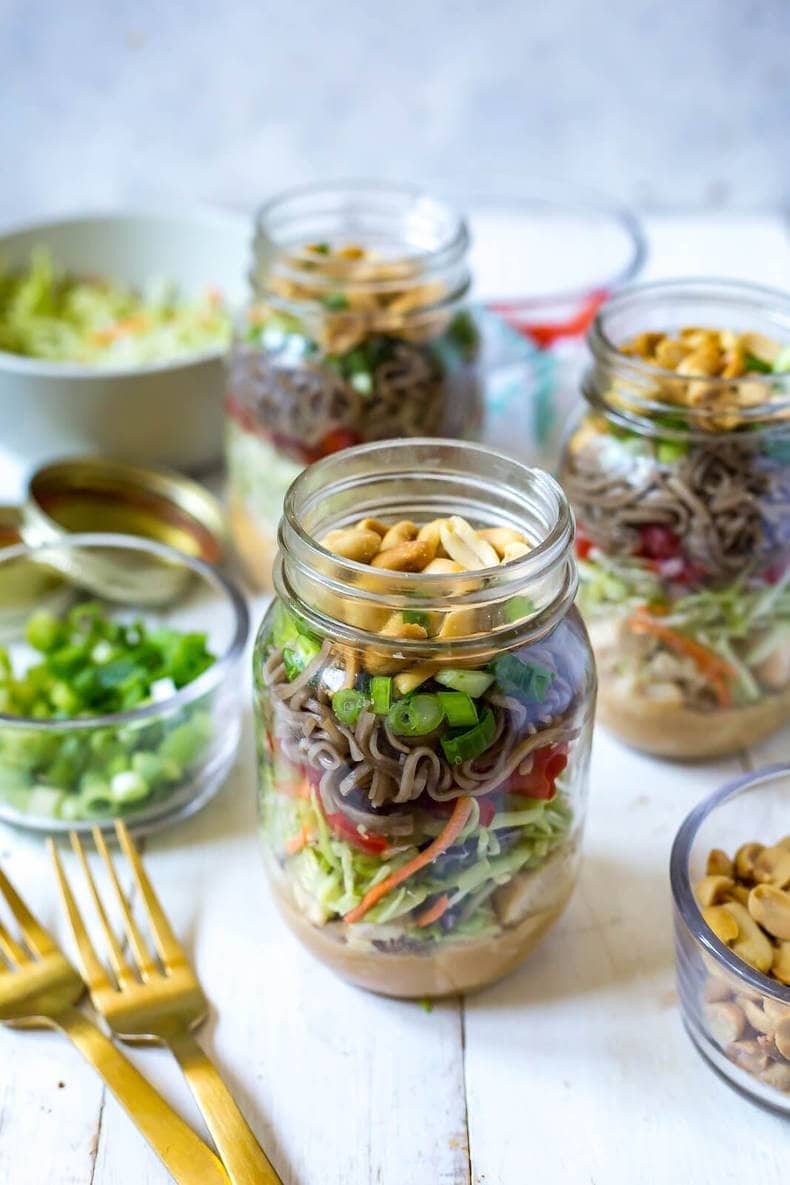 Thai chicken soba noodle salad on jars. 