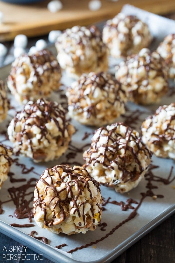Toffee Pecan Popcorn Balls on a tray with parchment paper