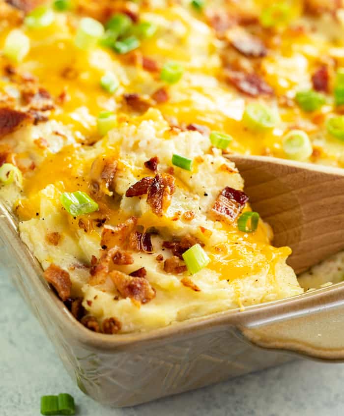 Cheesy potato casserole in a baking dish, topped with golden brown crust