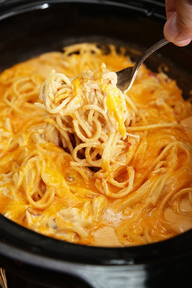 Fork scooping on a creamy  Crockpot Chicken Spaghetti