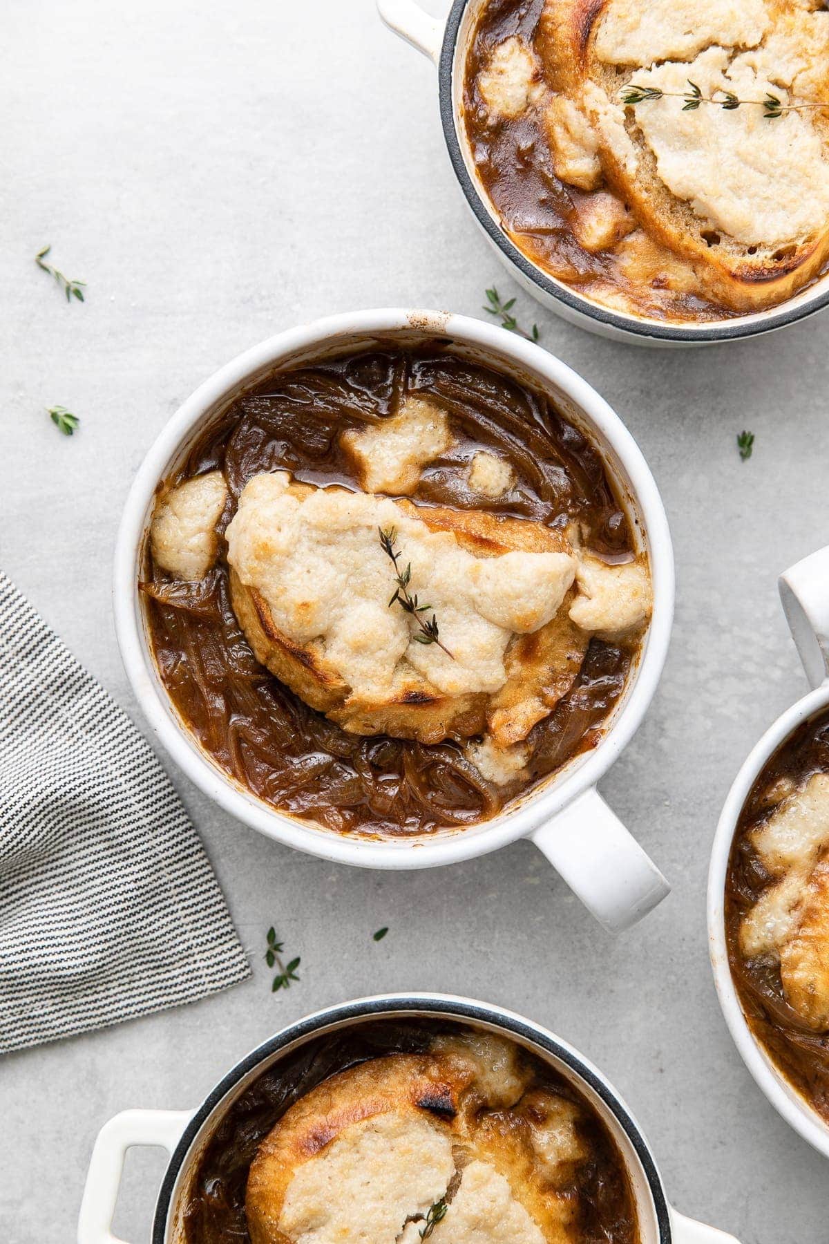 Bowl of homemade Vegan French Onion Soup garnished with thyme