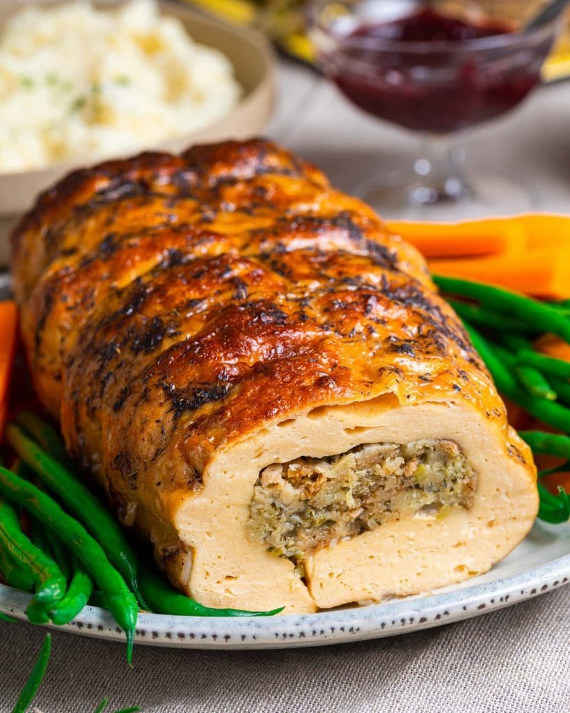 Turkey Roast roll with herb stuffing paired with greens and veggies.