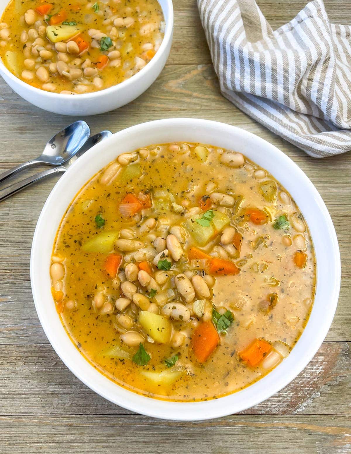 White Bean Soup with Carrots, Potatoes and Spices in a Bowl