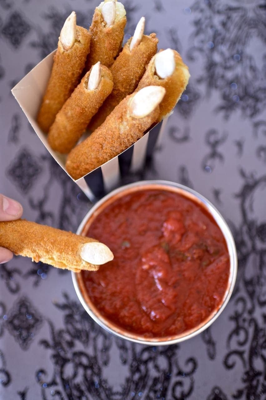 Witches fingers made with mozzarella sticks with marinara sauce. 
