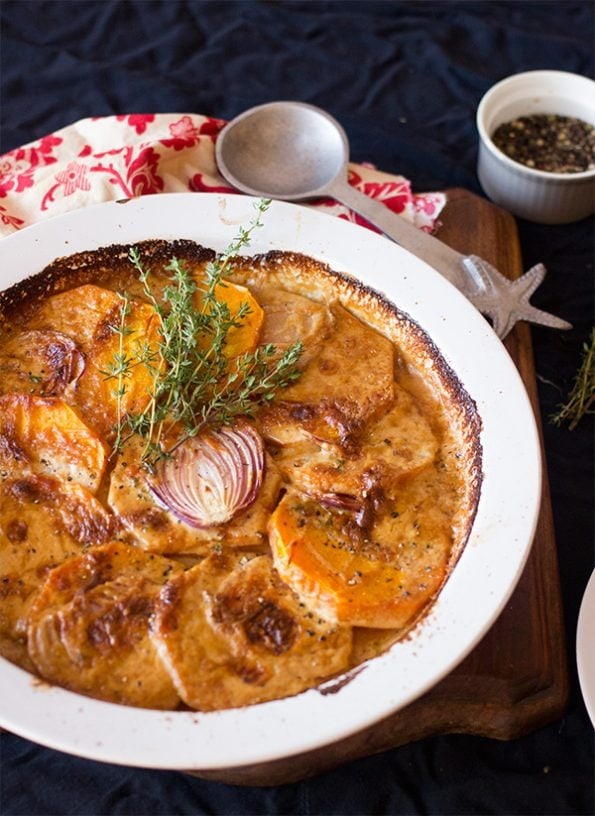 Whole serving of Butternut squash gratin served on a white plate. 