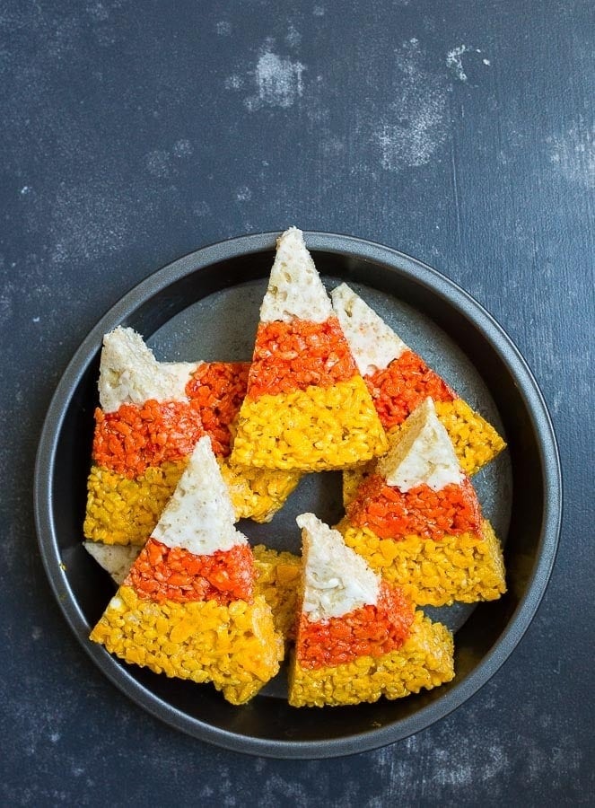 Candy corn shapes rice krispies on a plate. 