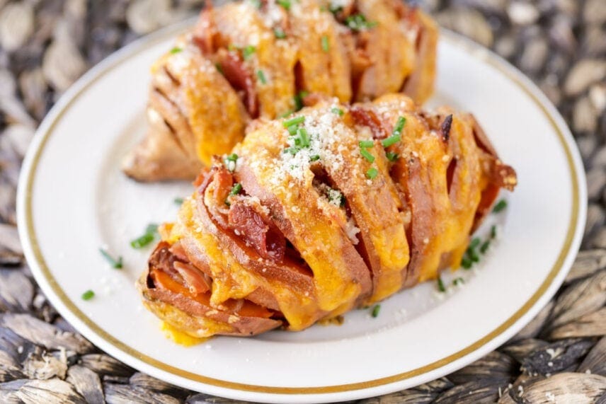 Cheesy hasselback sweet potatoes on plate. 