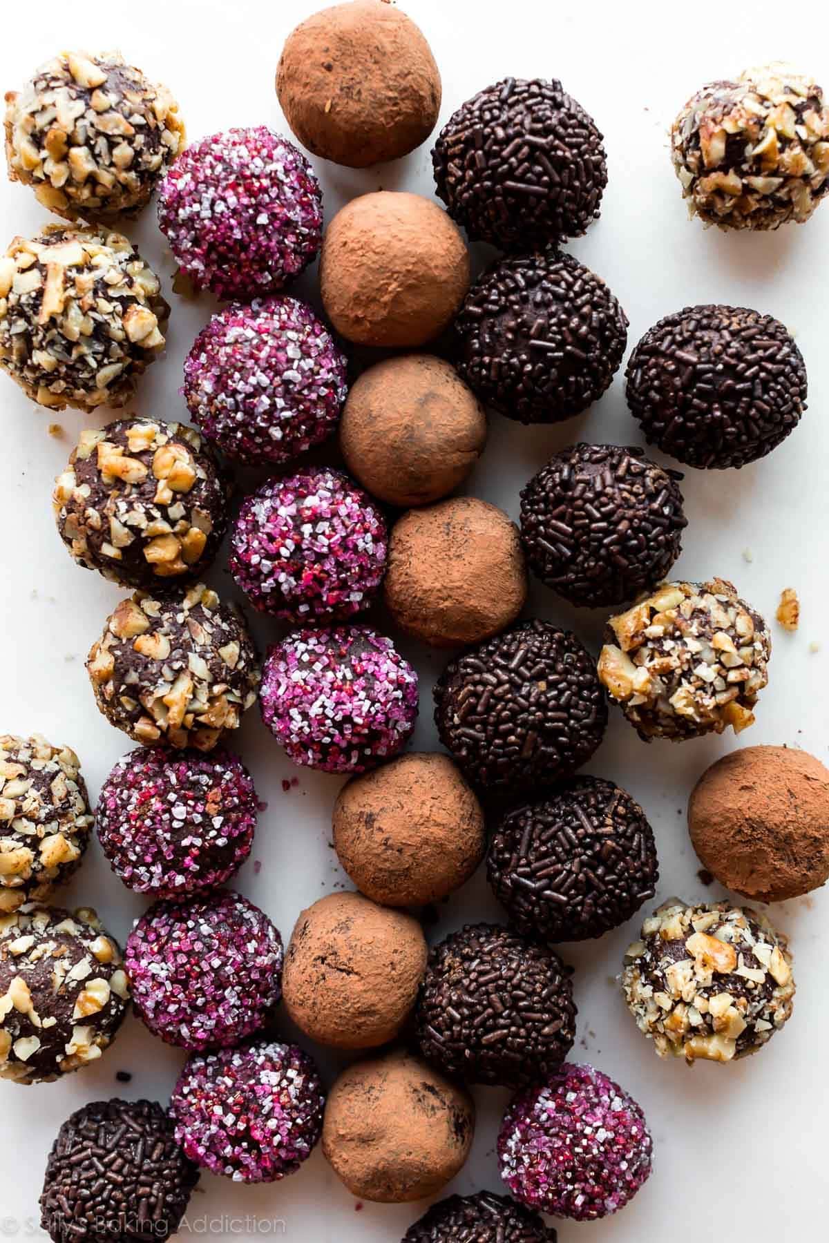 Chocolate truffles covered with nuts, sprinkles and chocolate powder. 