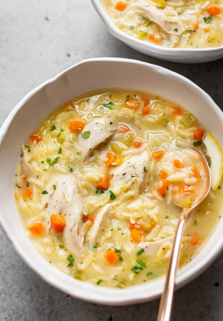 Warm Chicken Orzo Soup with Carrots and Parsley in a Bowl