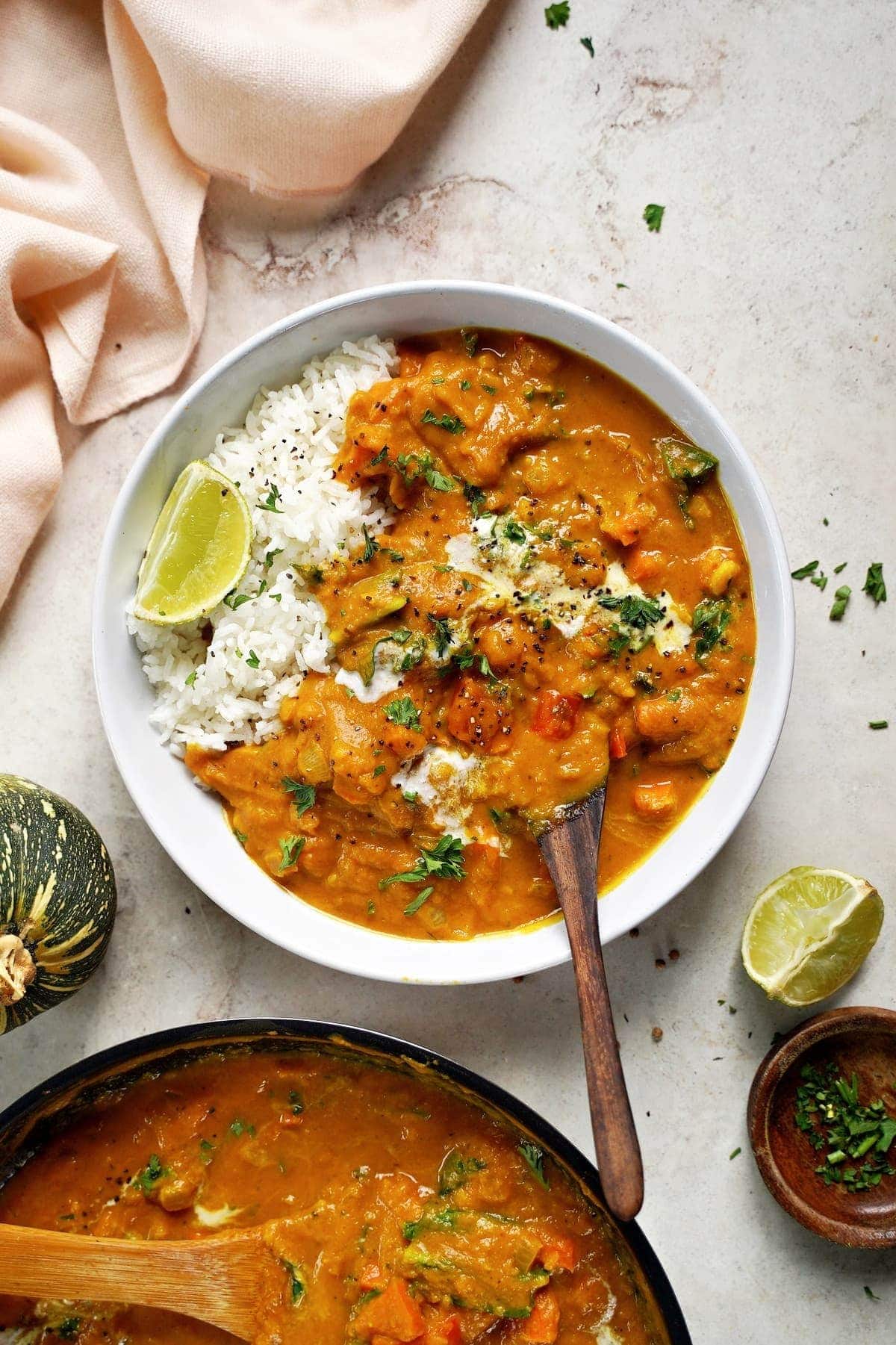 Rice topped with pumpkin curry with cream and chopped parsley. 