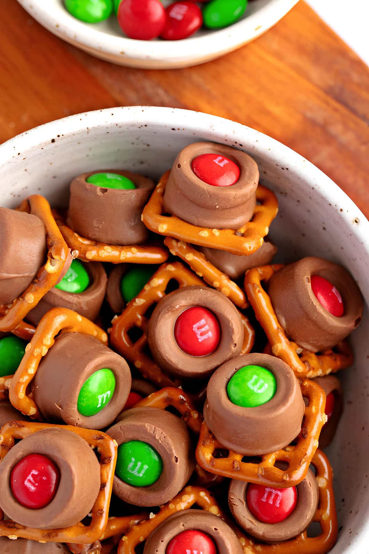 A bowl of chocolate pretzels topped with colorful M&M's, a delightful treat for any occasion