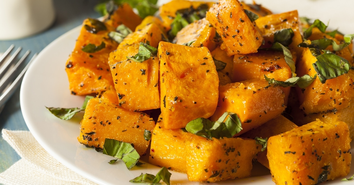 A plate of roasted butternut squash with herbs, a delicious and healthy dish