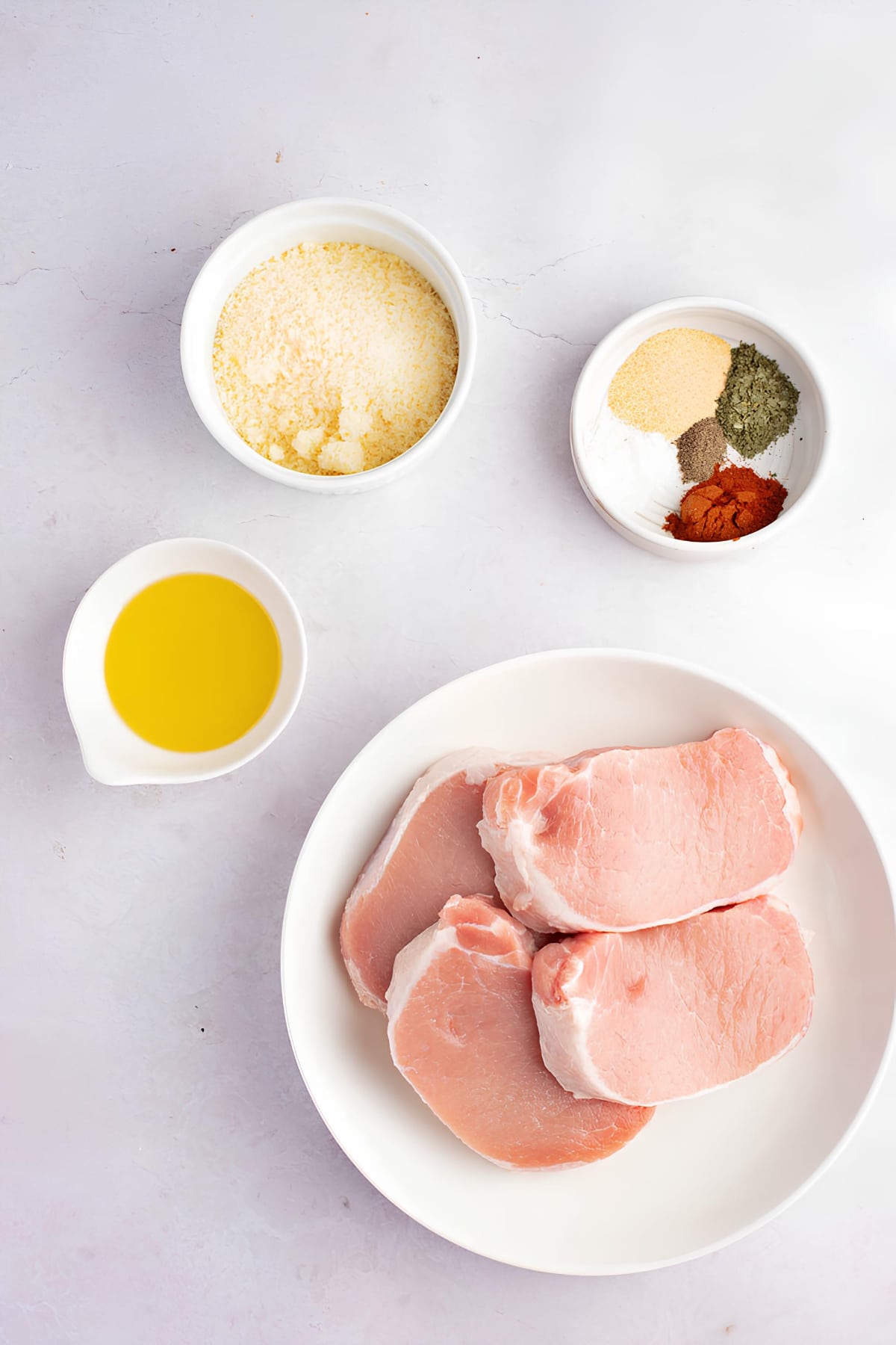 Air Fryer Pork Chops Recipe Ingredients: Fresh pork chops, bread crumbs, seasoning and olive oil. 