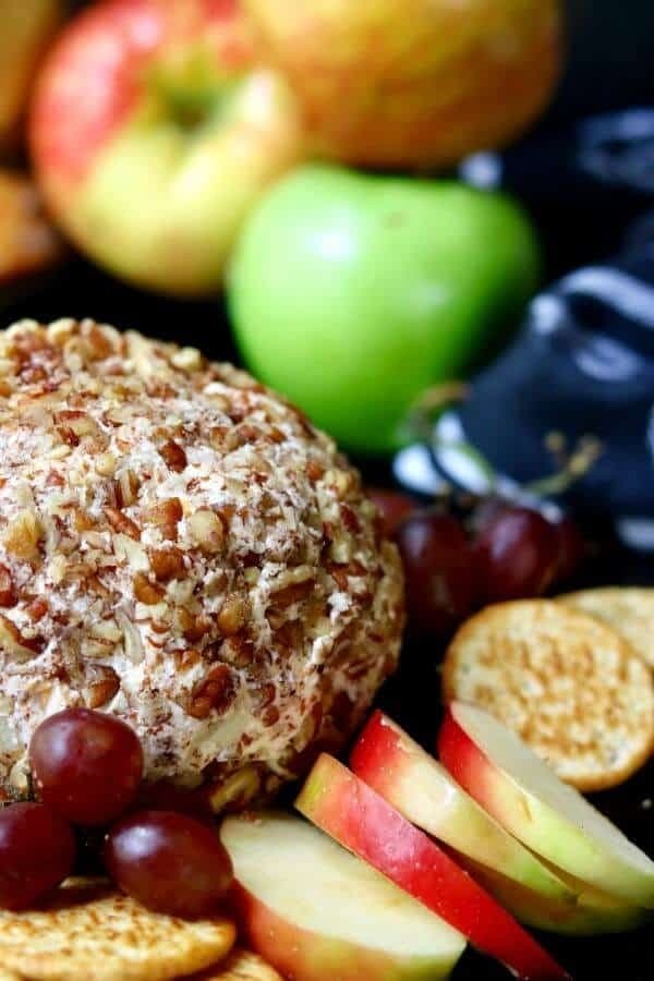 Cheeseball covered with chopped apples served with apple slices.