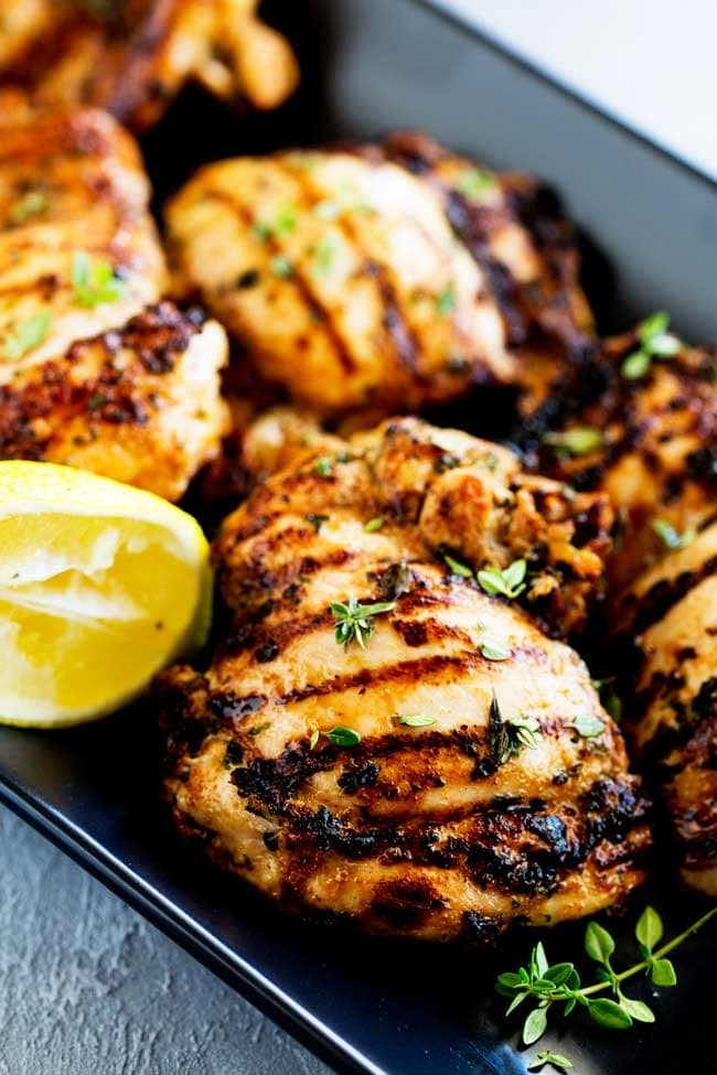 Apple Cider Thyme Grilled Chicken with lemon slice on the side