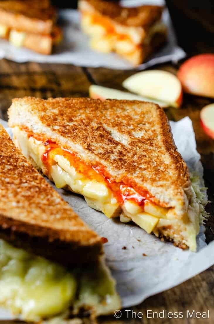 Sandwich with grilled cheese, ,apple and sriracha butter filling. 