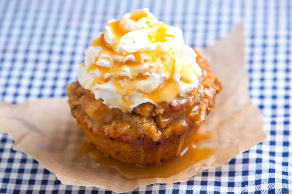 Apple pie cupcake topped with frosting and buttery streusel.