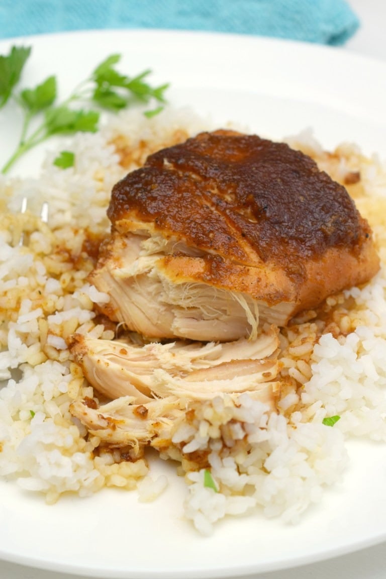 Applesauce BBQ Chicken served on a plate with rice and parsley