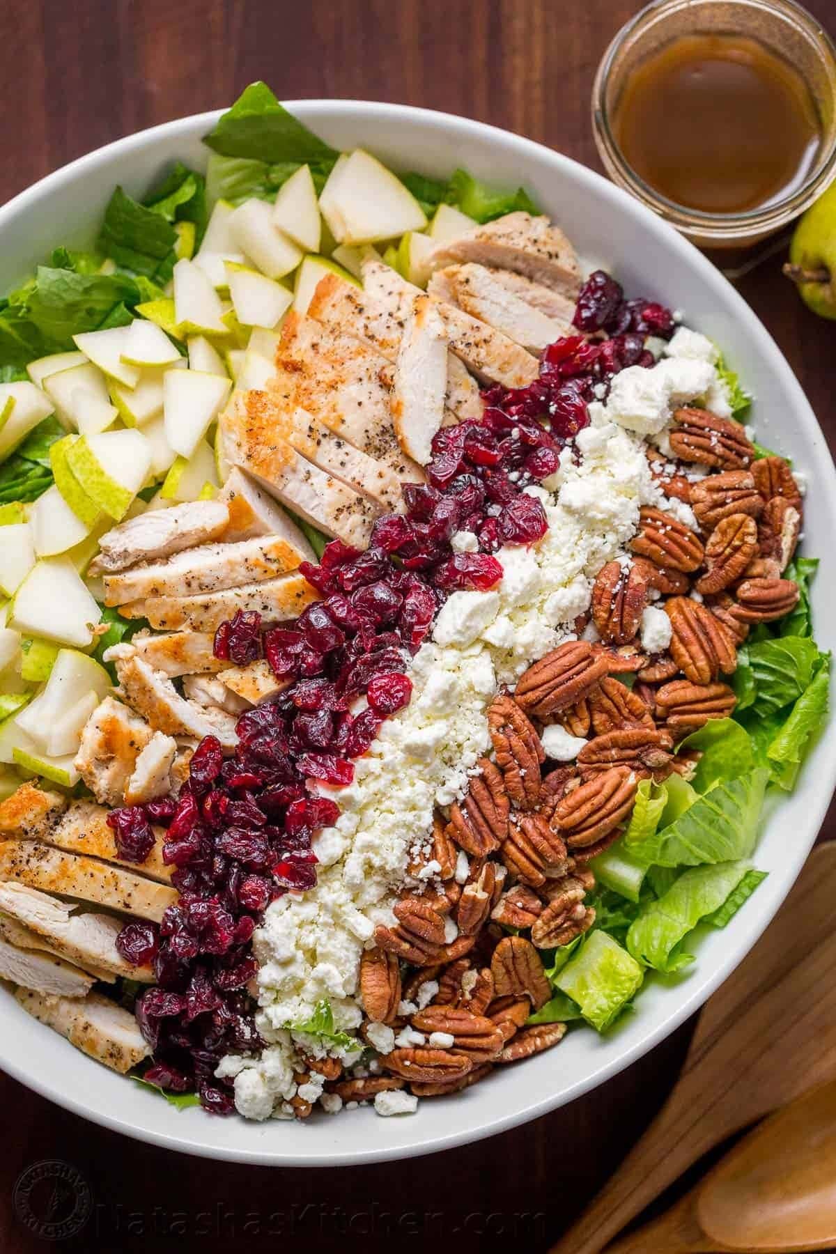 Autumn chopped chicken salad with  with crisp pears, tangy cranberries, toasted pecans, feta, and juicy chicken.