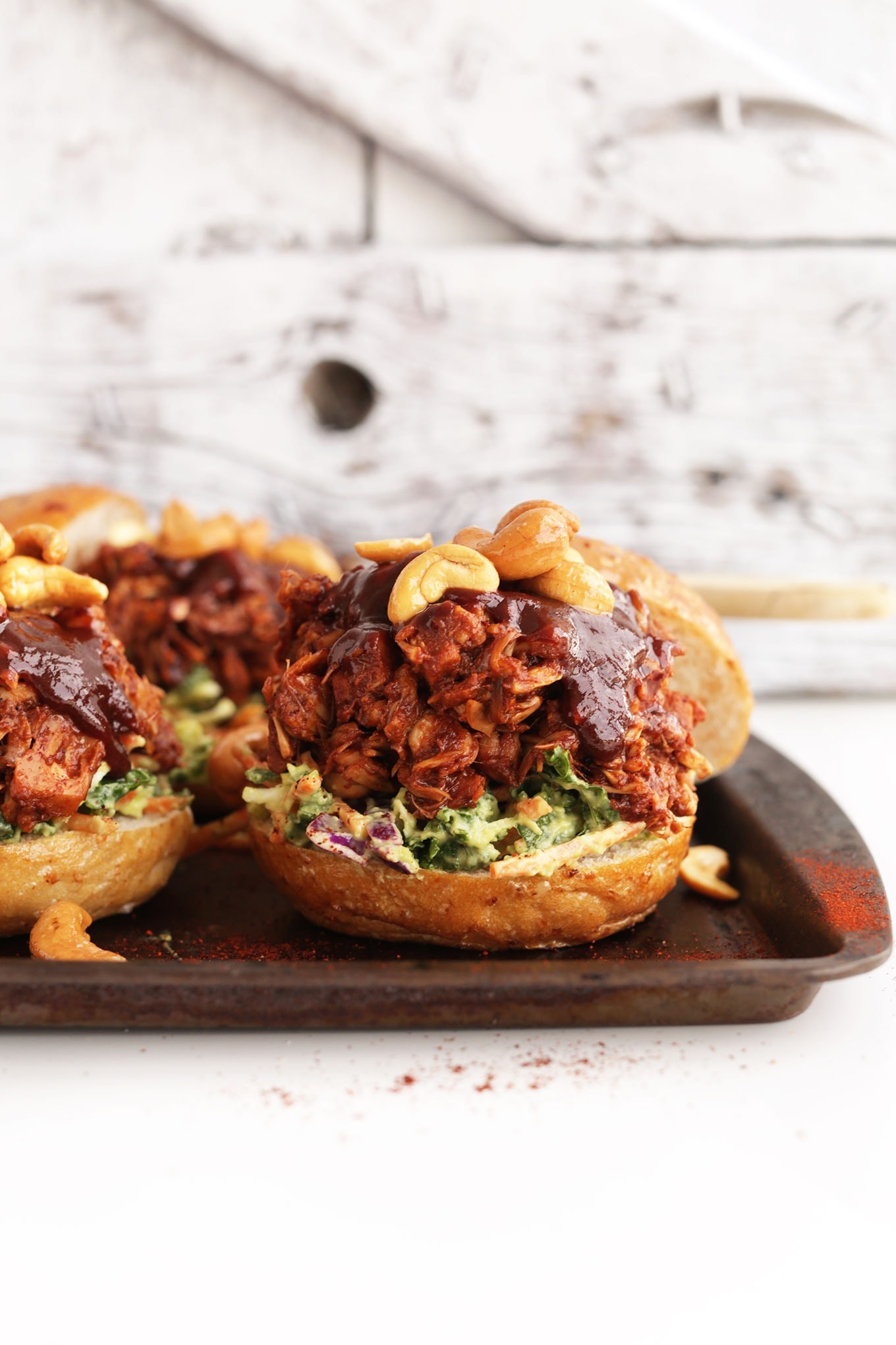 Sandwich with BBQ flavored jackfruit filling with dressing and nuts.