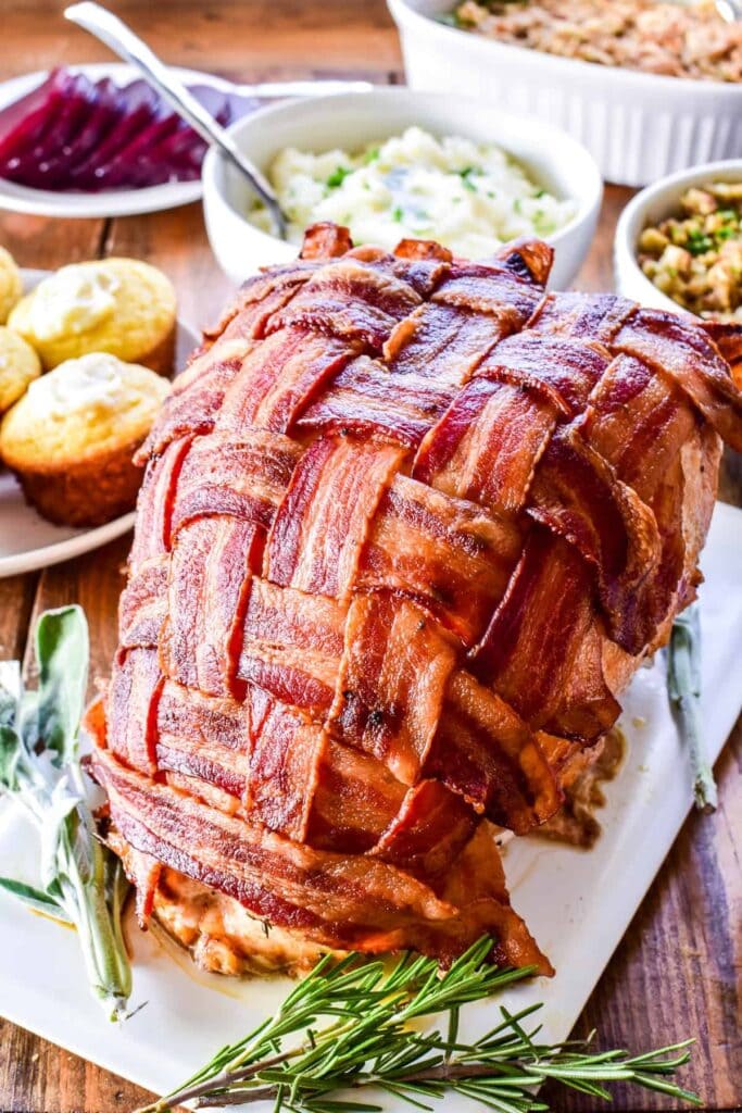 Turkey wrapped in bacon strips served on a plate. 