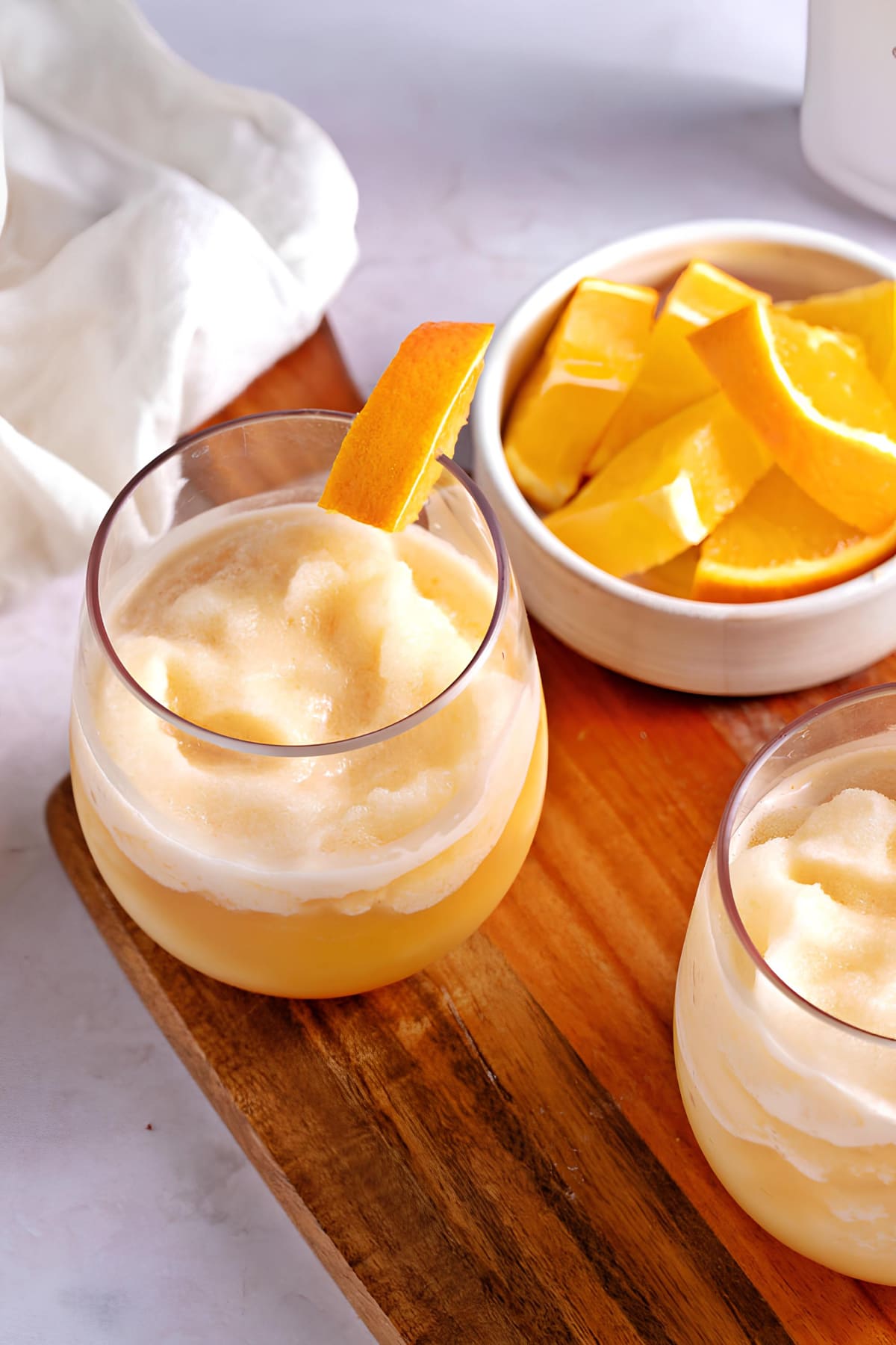 Frozen Bahama Mama in Glasses with Fresh Oranges