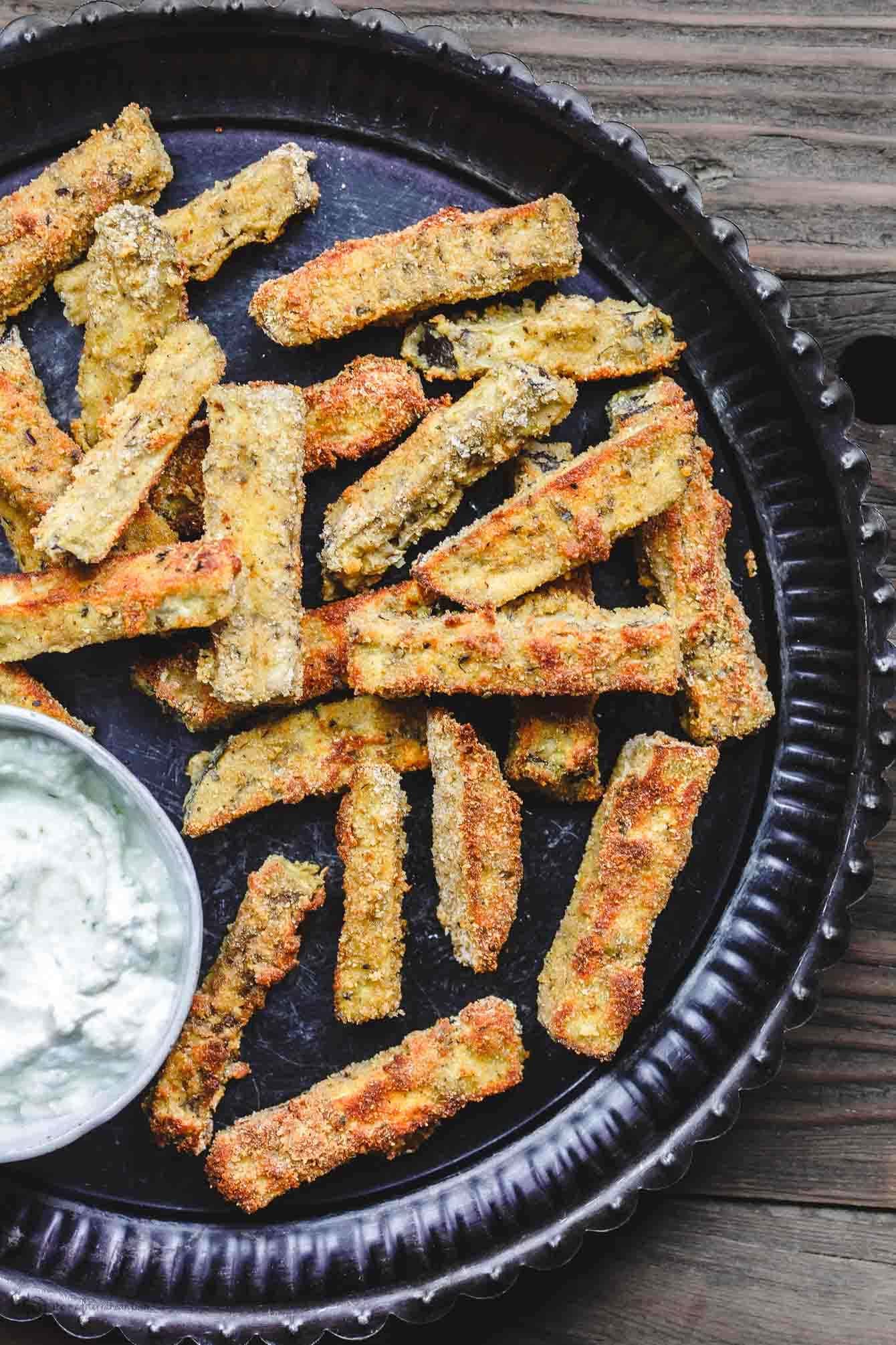 Breaded eggplant sticks served with white sauce. 