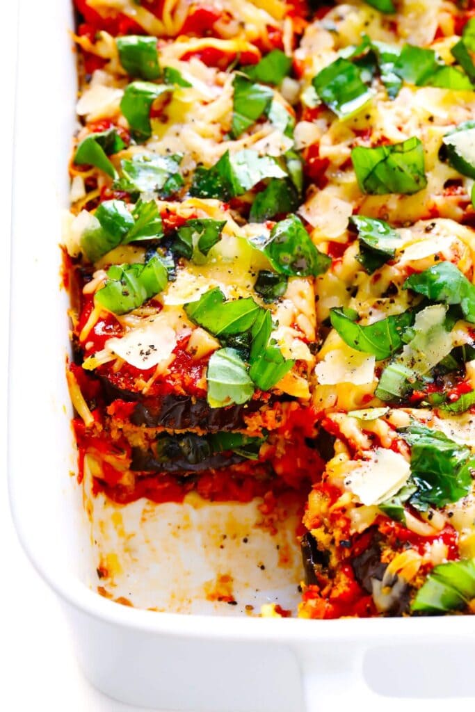 Eggplant parmesan in a casserole dish made with layered eggplant, cheese, herbs, and marinara.