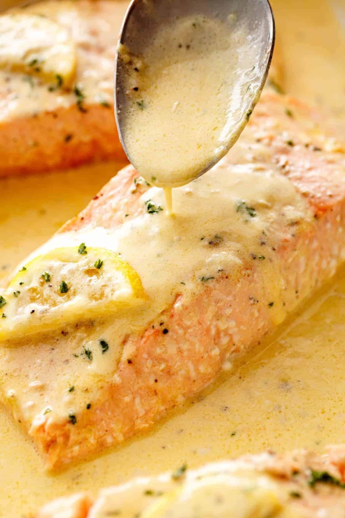 A slice of salmon with lemon butter cream sauce. 