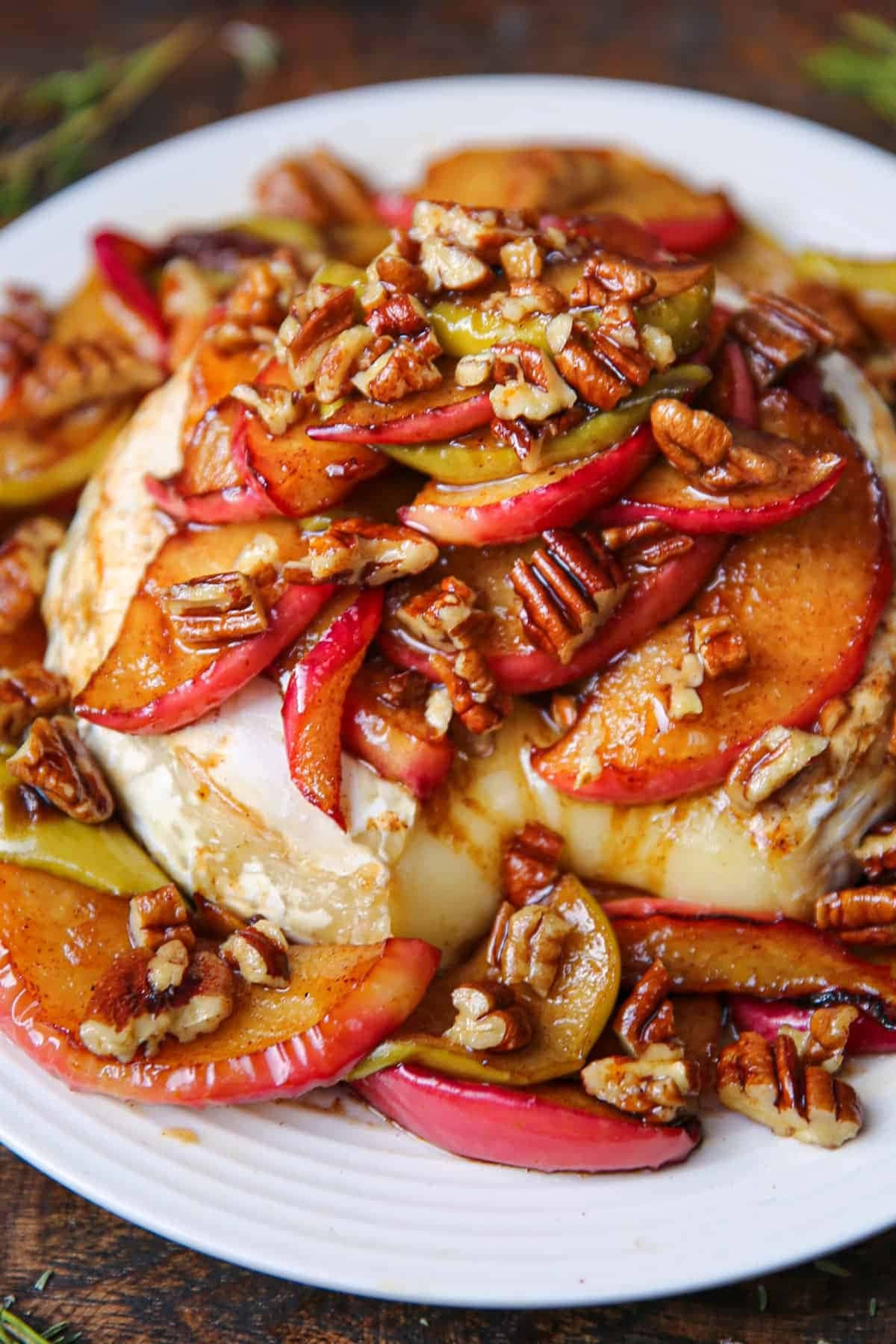 Baked brie with caramelized apples with pecan nuts on top. 