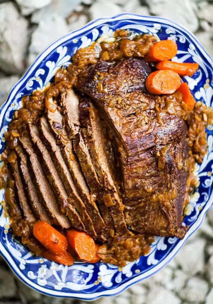  A plate with a delicious beef brisket roast and carrots.