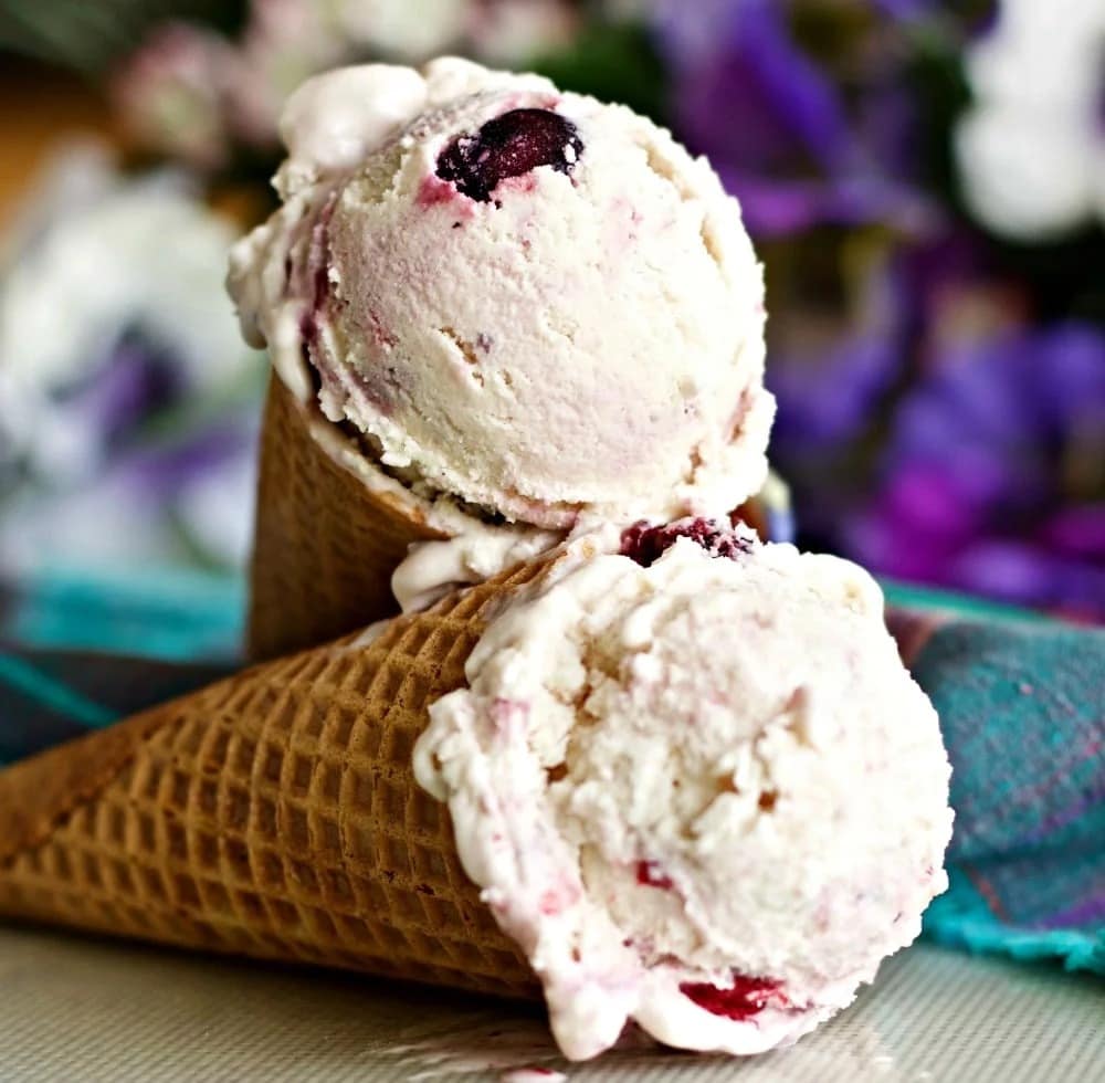 Scoops of Berry Buttermilk Ice Cream on ice cream cones