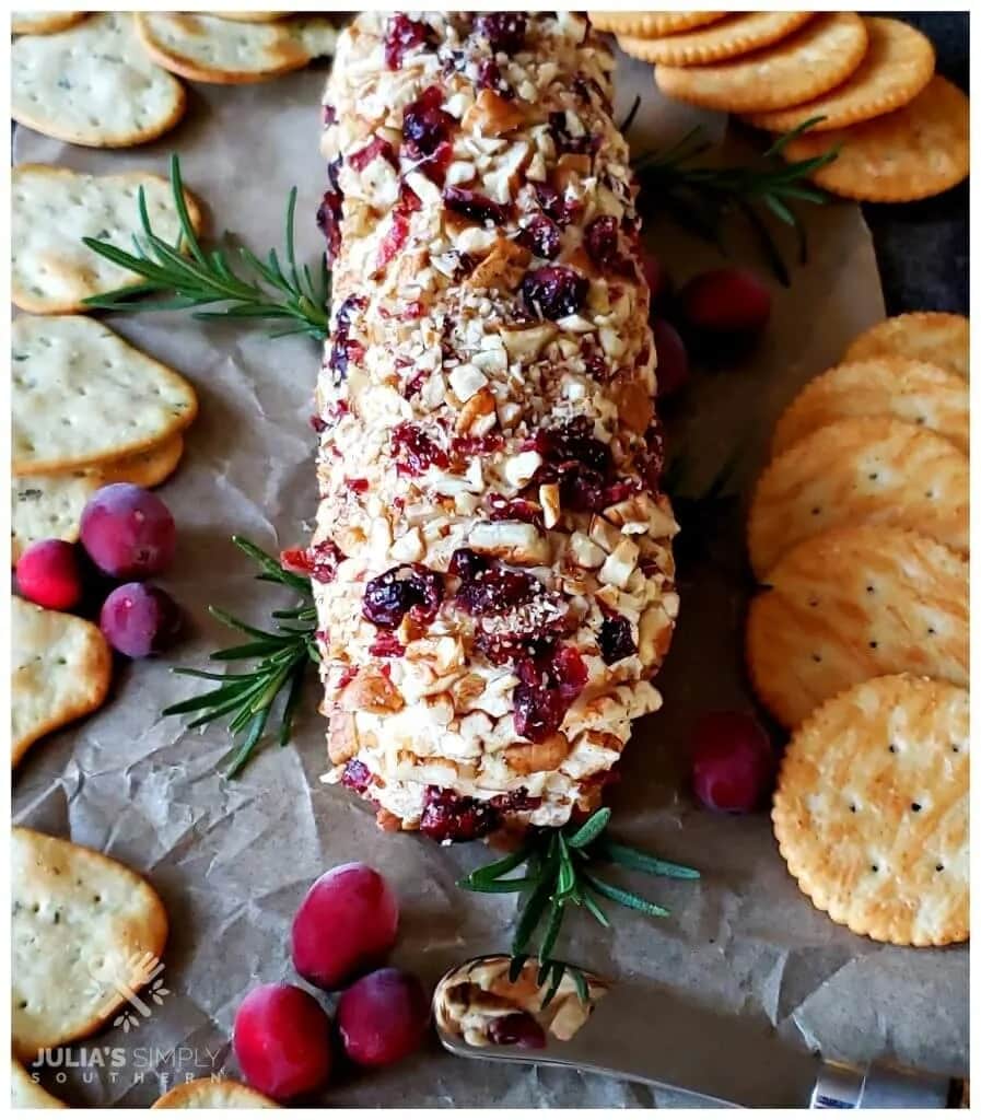 Rolled cheeseball coated with chopped pecans and dried cranberries.