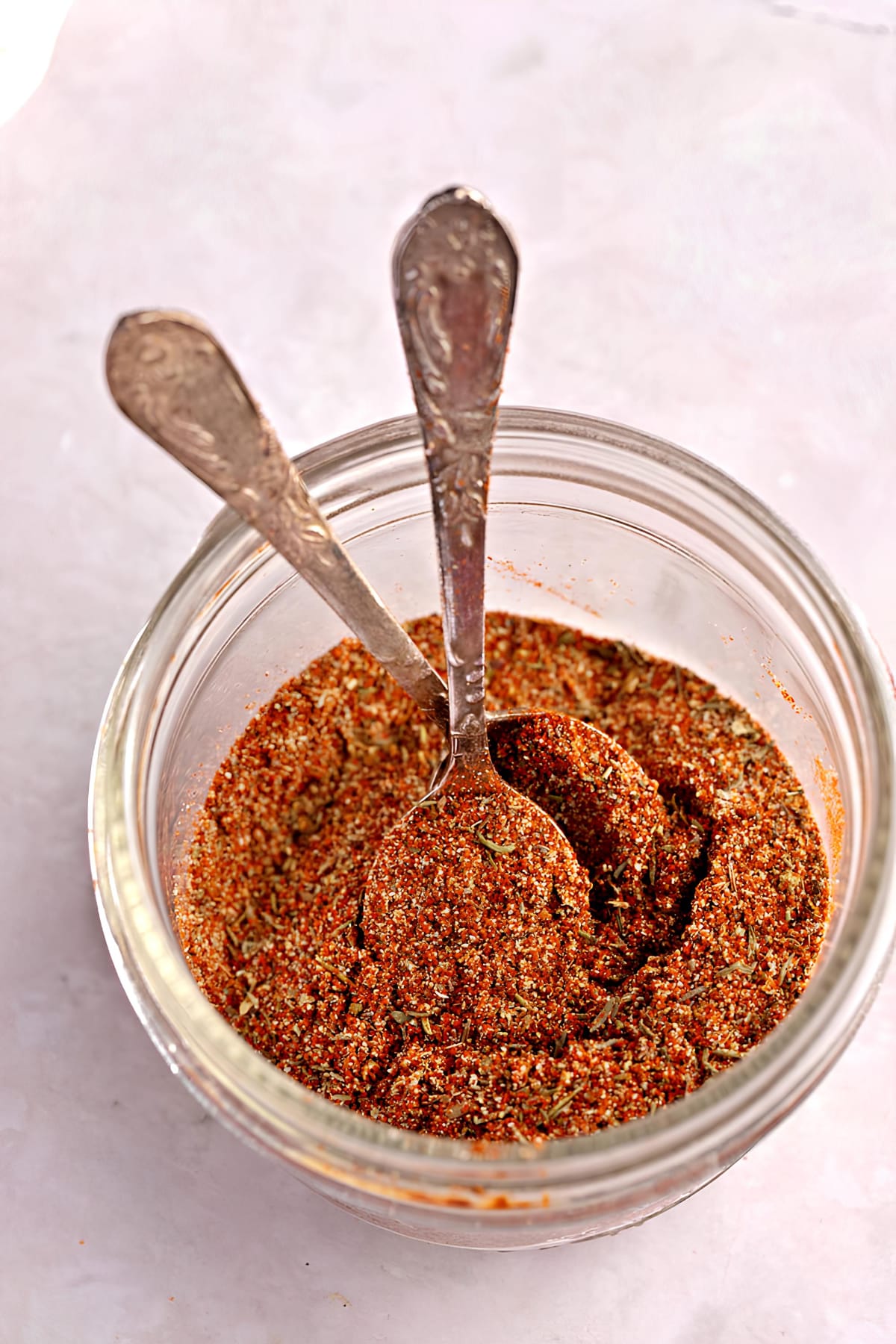 Raw Organic Blackened Seasoning in a Glass Jar with Two Spoons