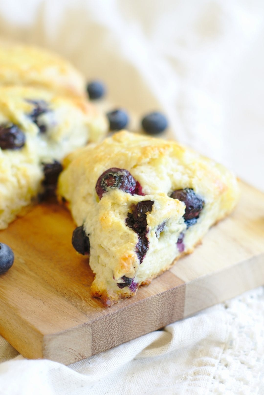 A slice of blueberry scones on a wooden board.