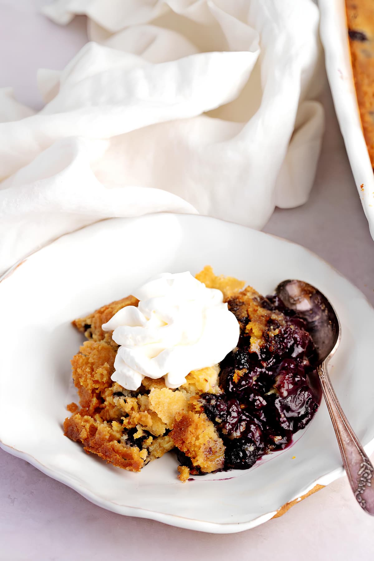 Sweet and Soft Homemade Blueberry Dump Cake with Whipped Cream