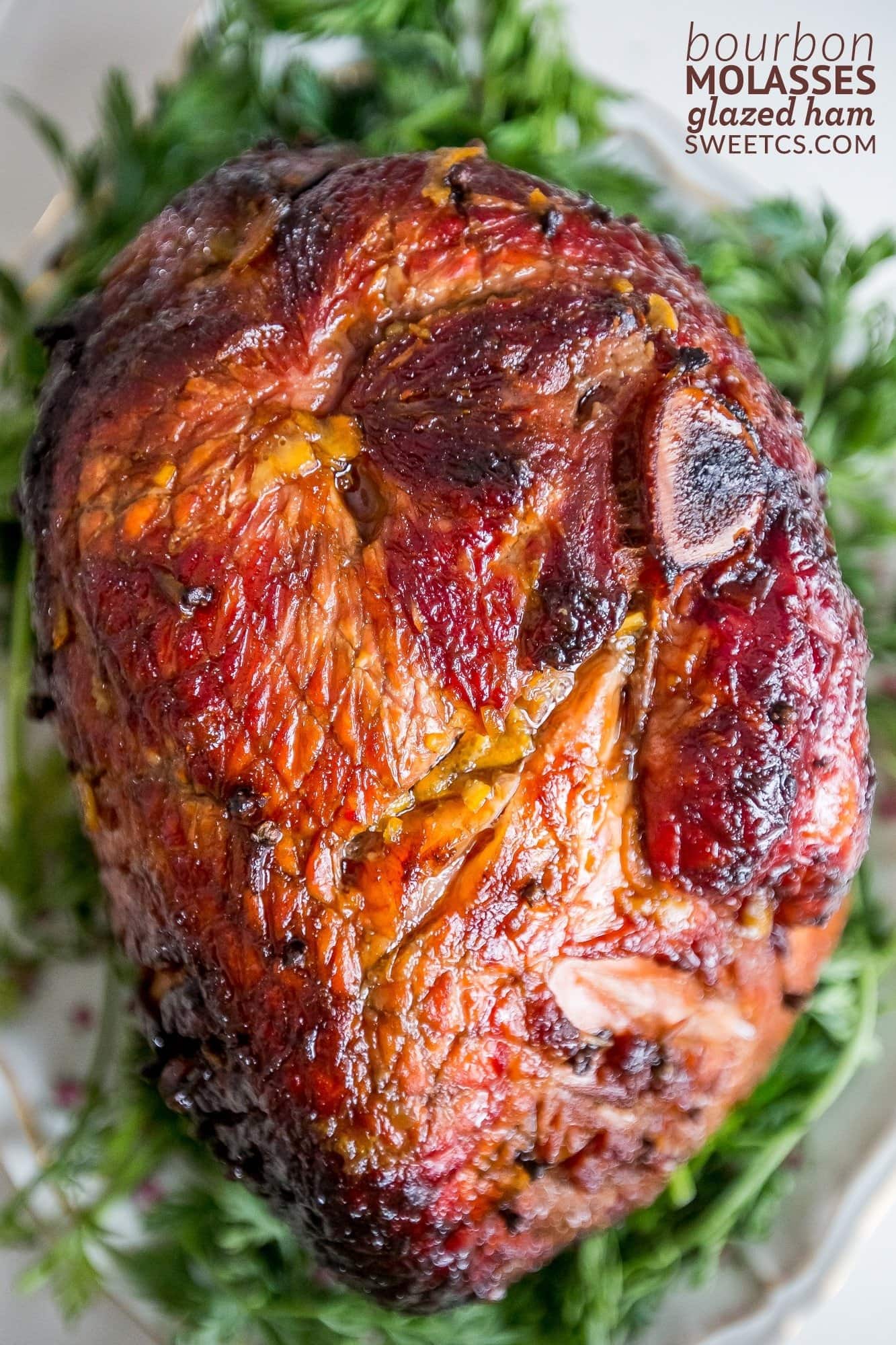 Closeup of whole glazed ham on a plate. 