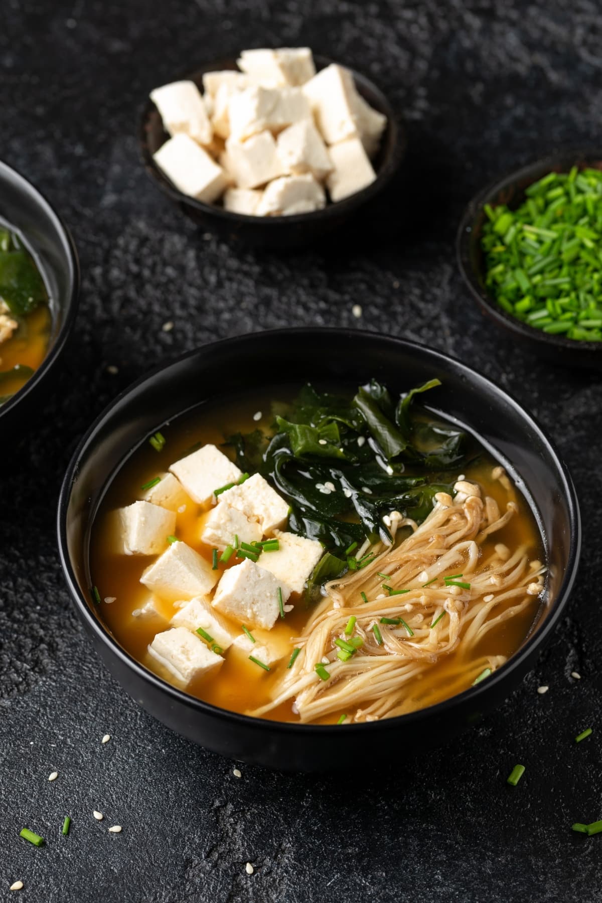 Rich miso soup with enoki mushrooms, tofu and seaweeds