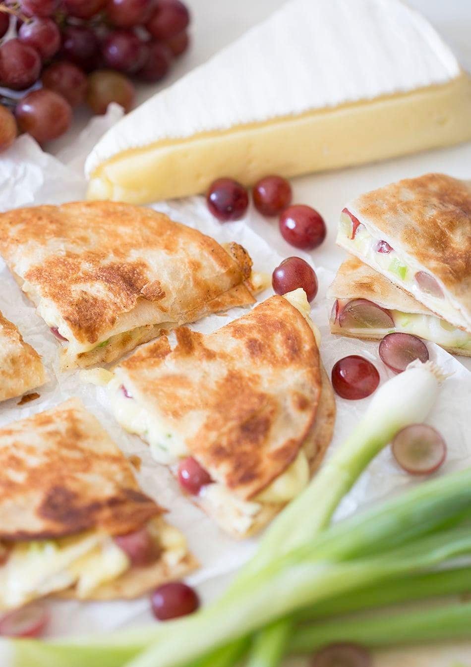 Quesadilla with melted brie, sweet grapes, and scallions. 