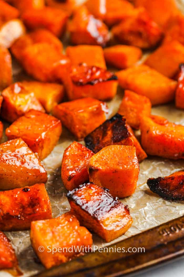 Brown sugar roasted sweet potatoes on a sheet pan.