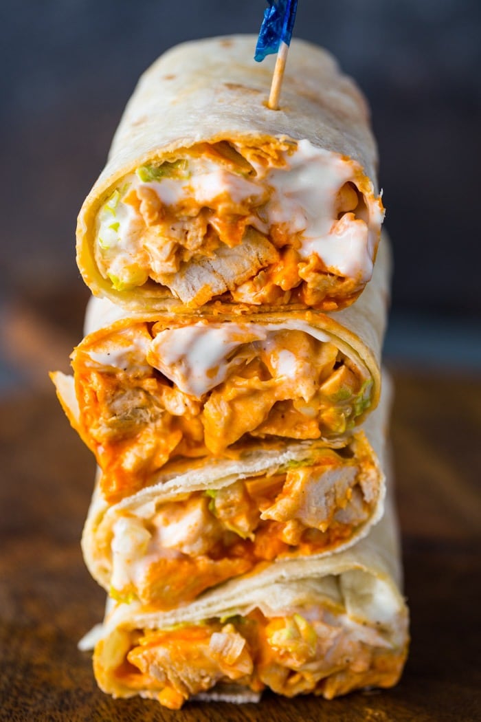 Stack of chicken wraps with buffalo sauce filling. 