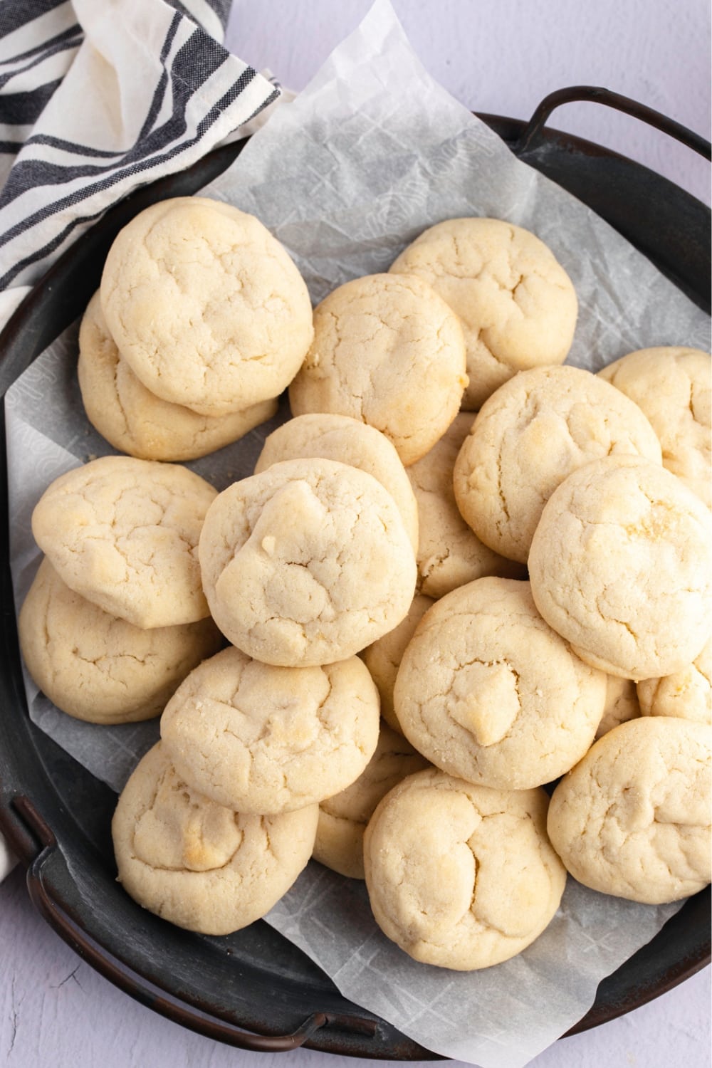 Bunch of sugar cookies served on a pan with parchment paper